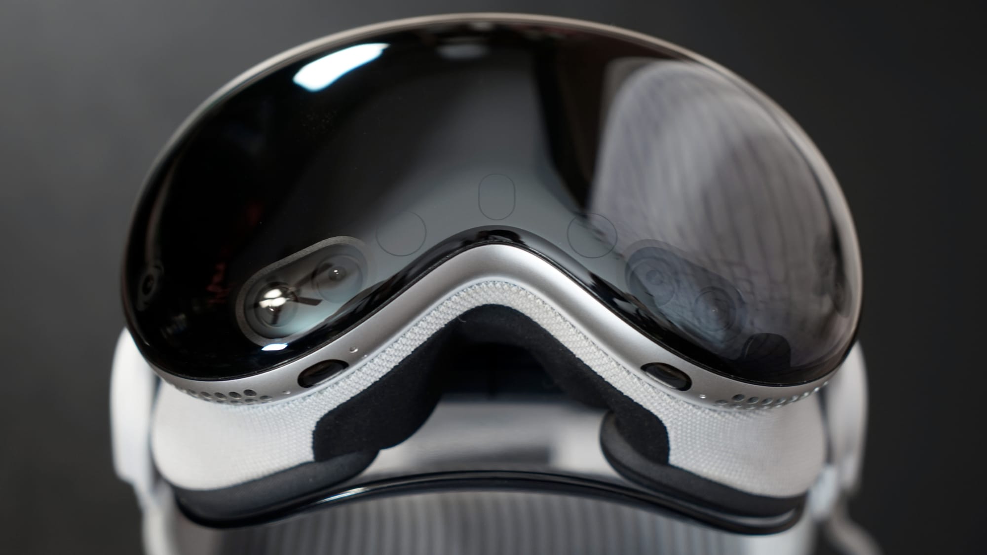 A close-up shot of the Apple Vision Pro on a stand
