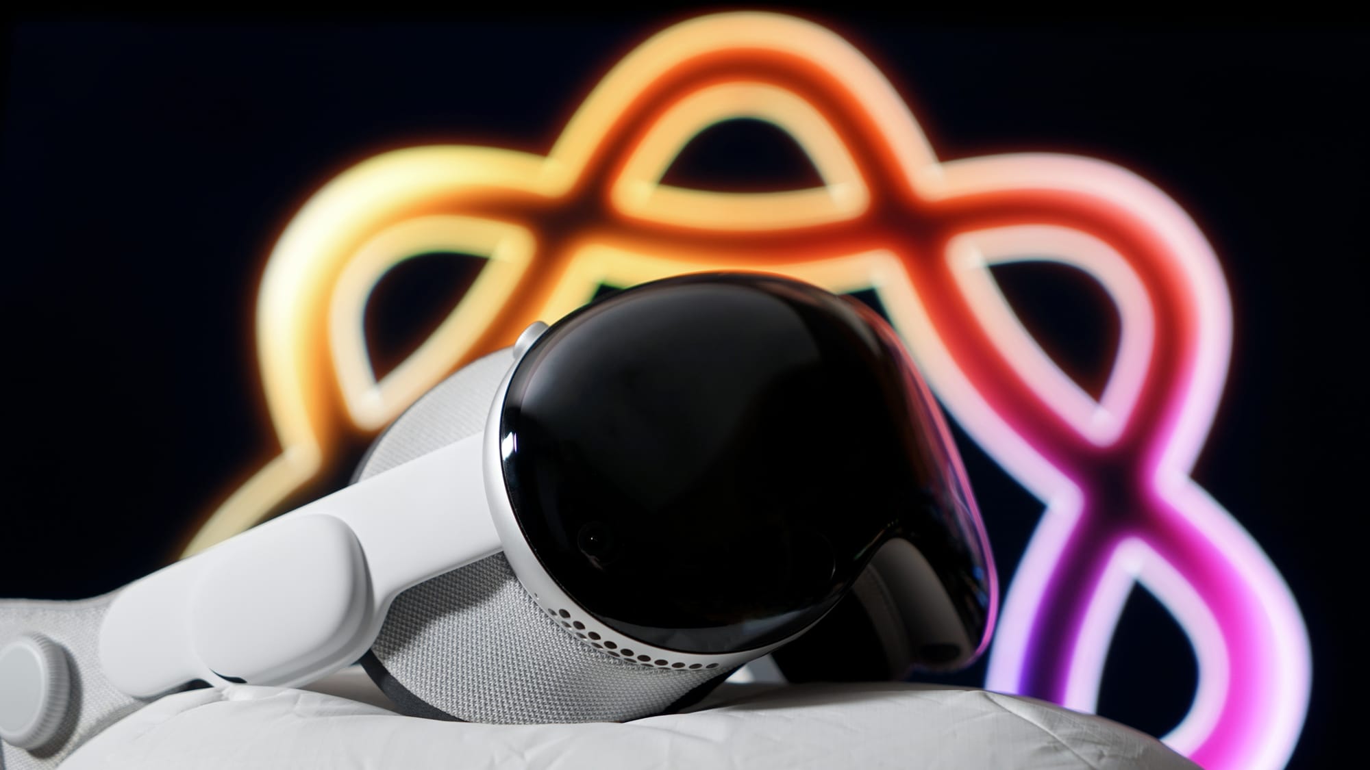 Apple Vision Pro in front of an Apple Intelligence logo