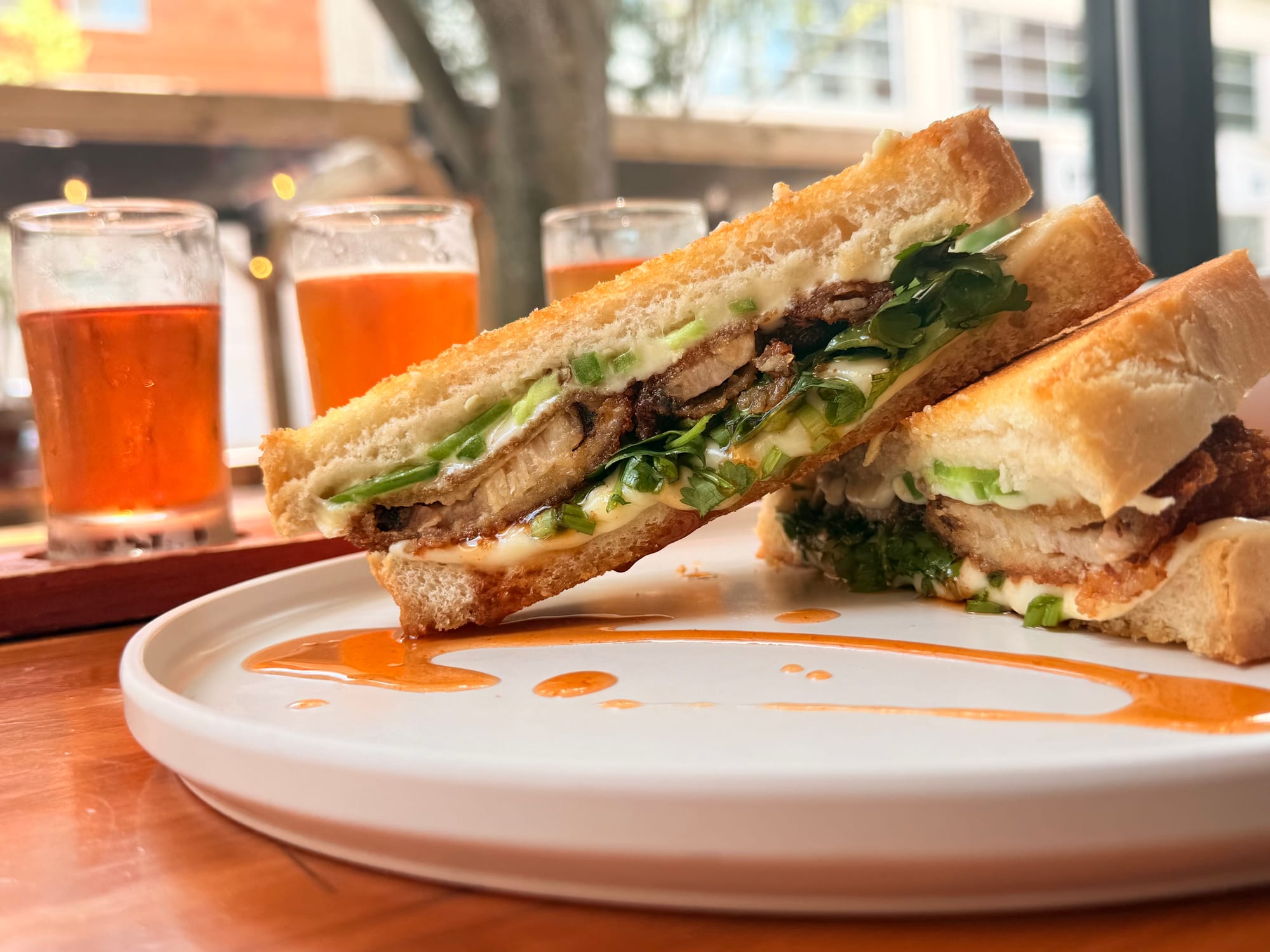 A specialty grilled cheese sandwich with brisket sliced in half