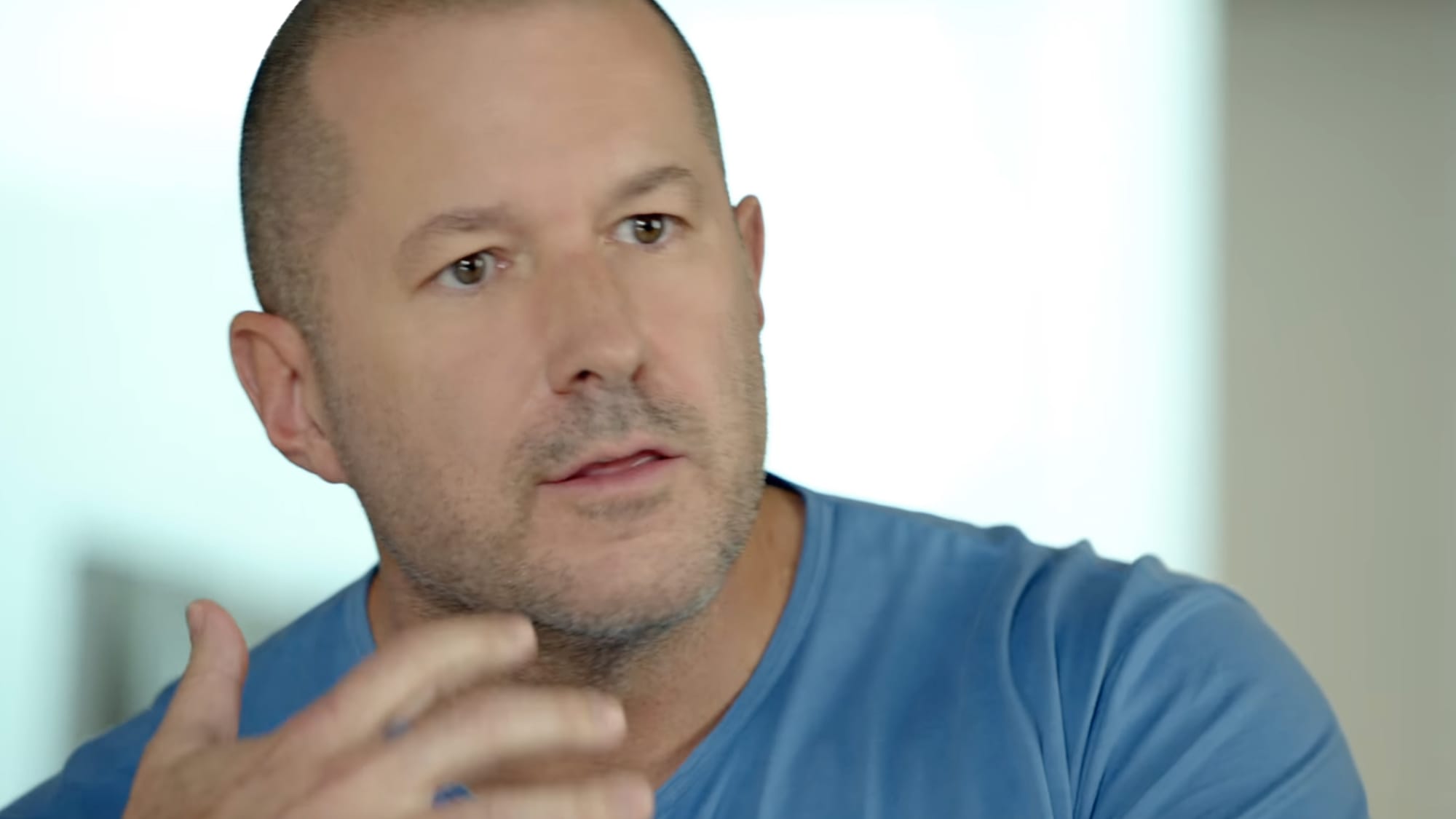 Jony Ive gesturing at the camera in a promotional video