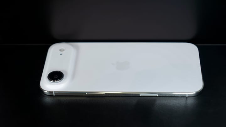 The iPhone Air shown on a dark background and a reflective surface.